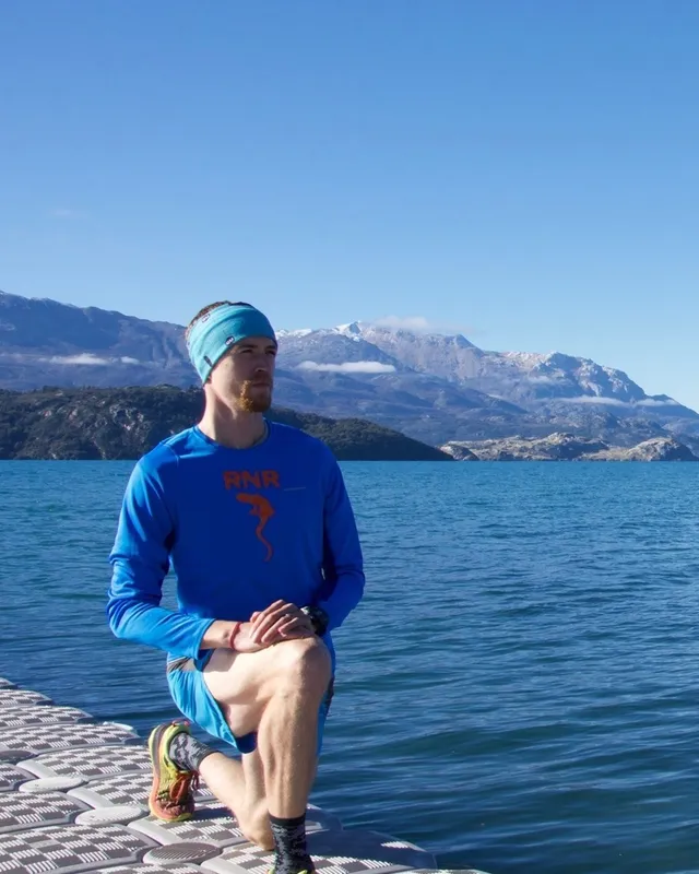 Dr Silas Carey, physiotherapist and owner of Coast Physio, beside a South Island lake