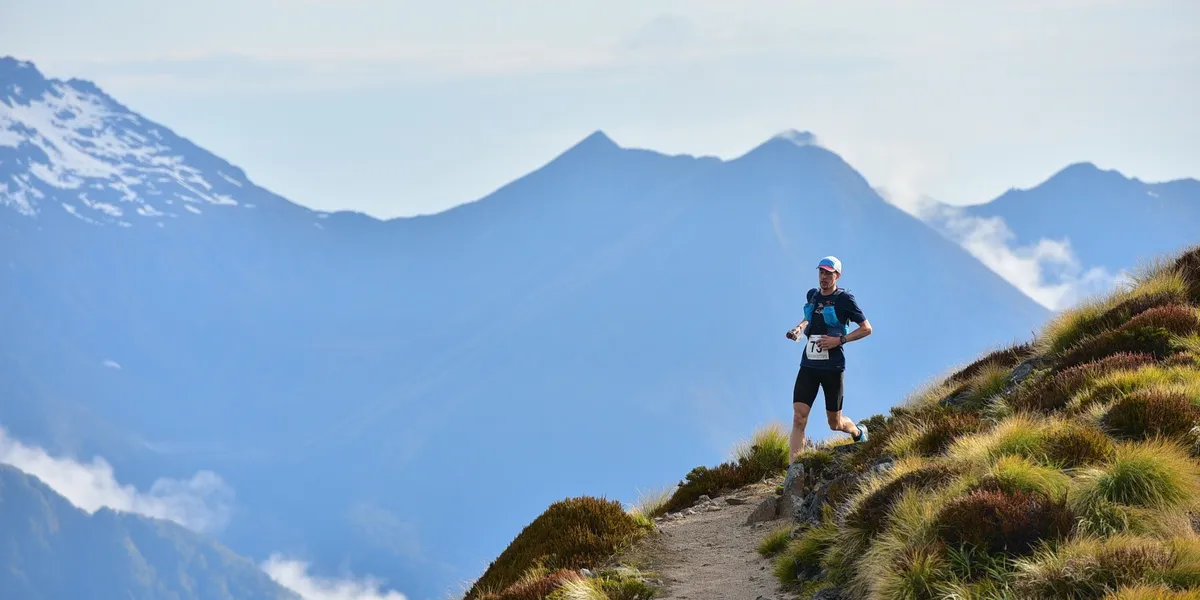 Dr Silas Carey trail running on a mountain ridge above the clouds